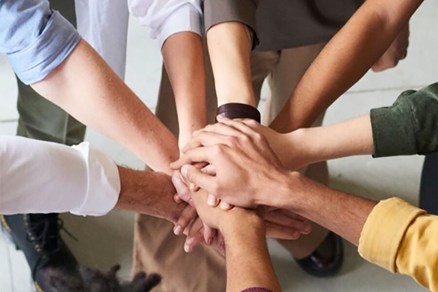 People joining hands in teamwork